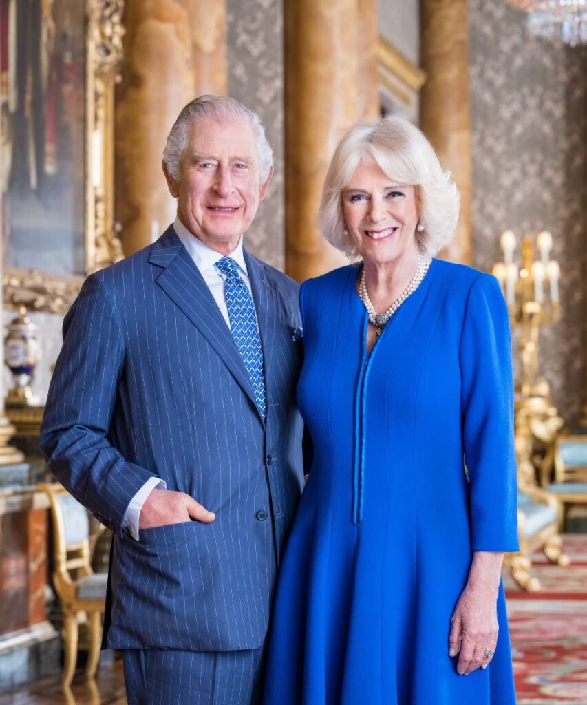 The King and The Queen, in the Blue Drawing Room at Buckingham Palace.